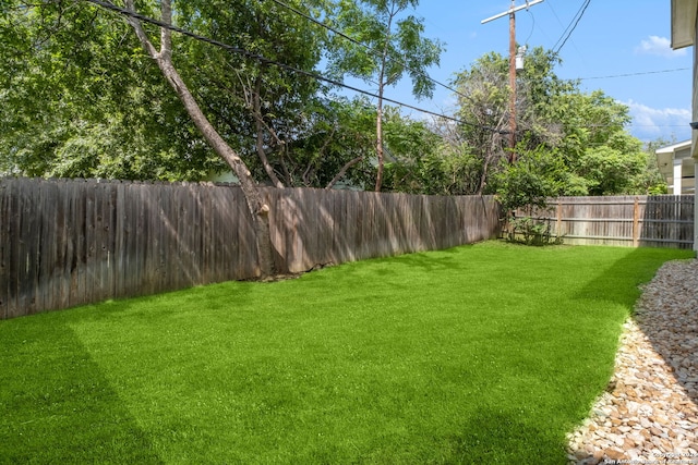 view of yard with a fenced backyard