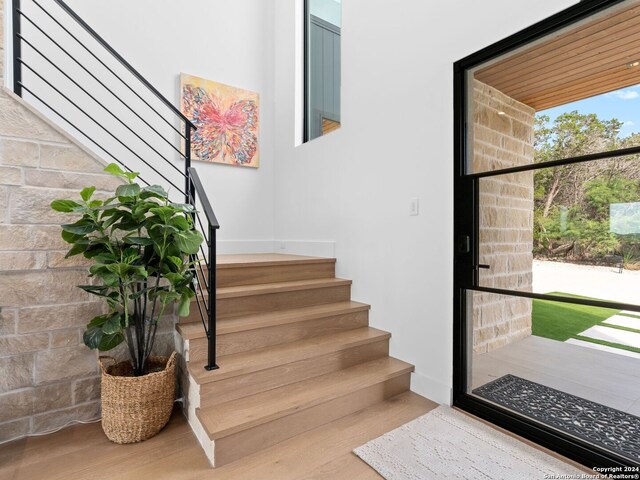 stairs with wood-type flooring