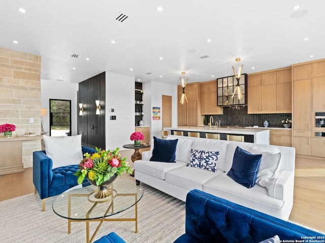 living area featuring light wood-style floors, visible vents, and recessed lighting