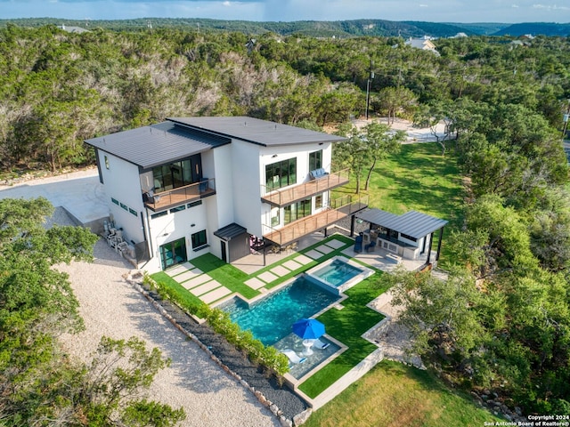 birds eye view of property featuring a view of trees