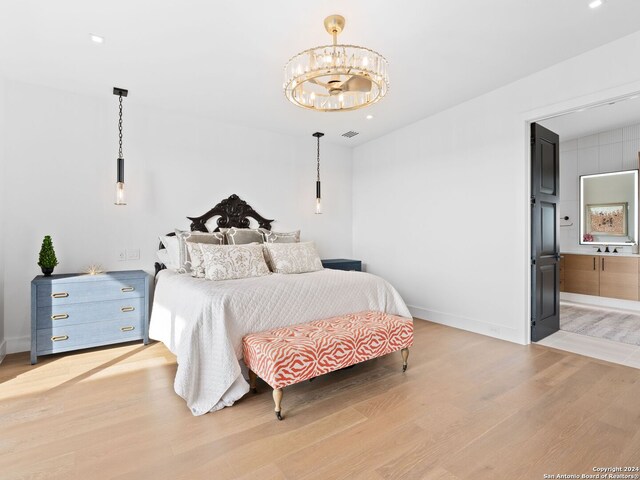 bedroom featuring light hardwood / wood-style floors and a notable chandelier