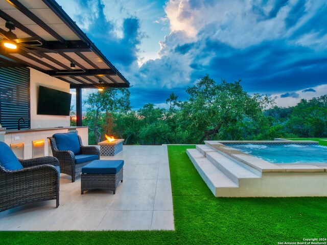 view of swimming pool with pool water feature, a patio area, a jacuzzi, and a yard