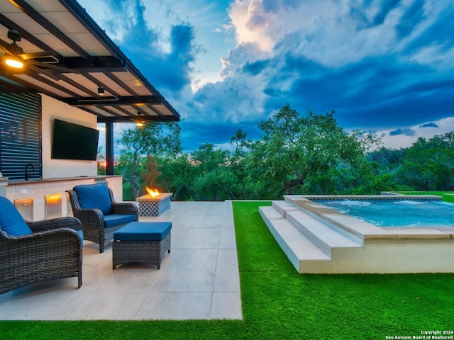 exterior space featuring an infinity pool, a fire pit, and a sink