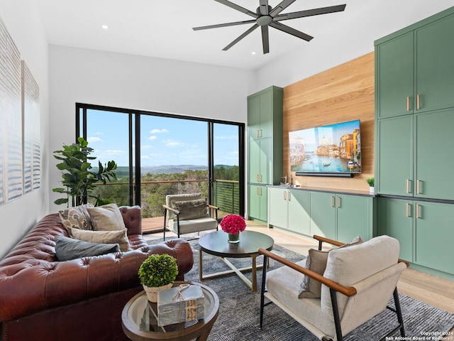 living room with hardwood / wood-style flooring and ceiling fan