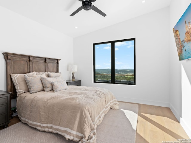 bedroom featuring light hardwood / wood-style flooring and ceiling fan