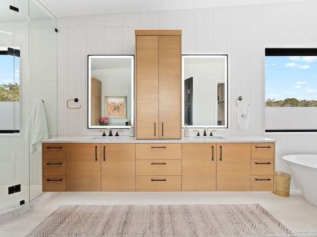 bathroom featuring dual bowl vanity, lofted ceiling, and a healthy amount of sunlight