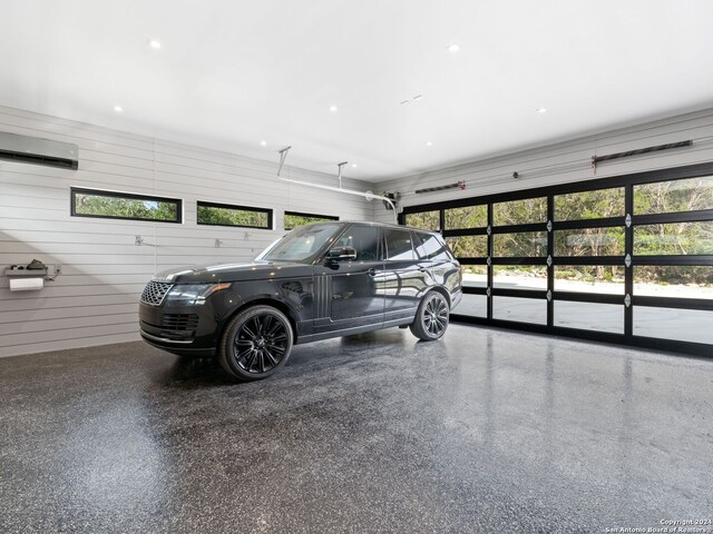 garage featuring a wall mounted AC