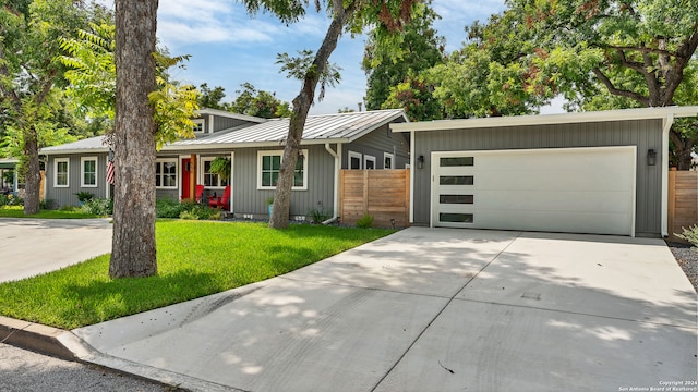 ranch-style house with a garage and a front lawn