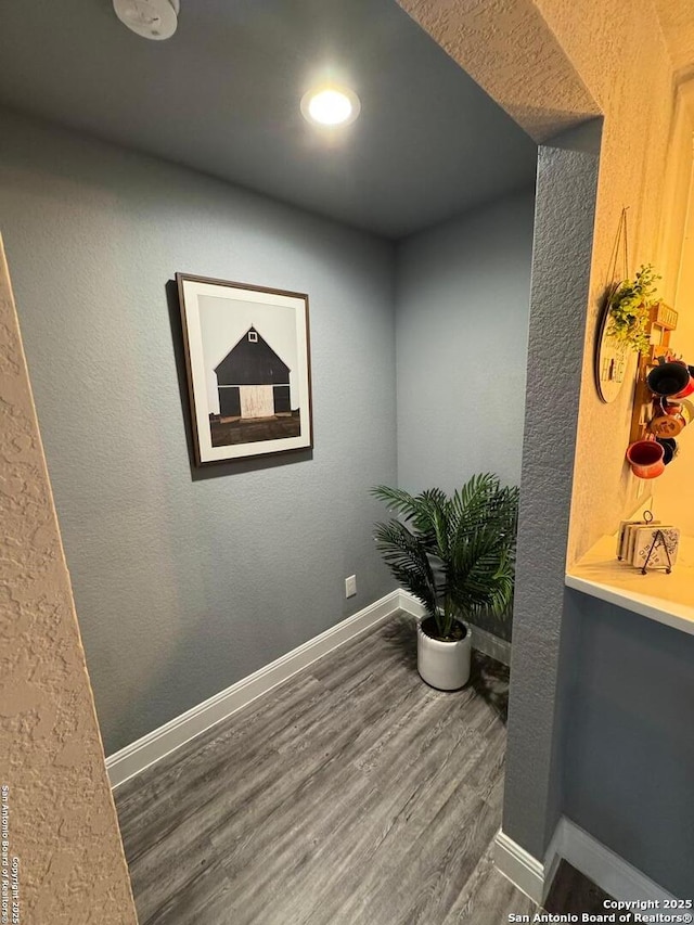 hallway with dark wood-type flooring