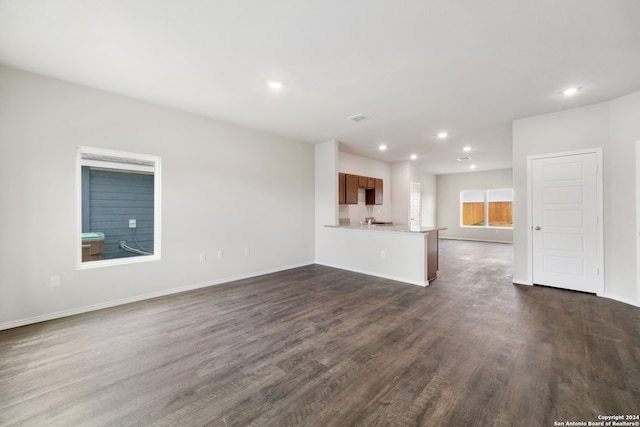 unfurnished living room featuring dark hardwood / wood-style floors