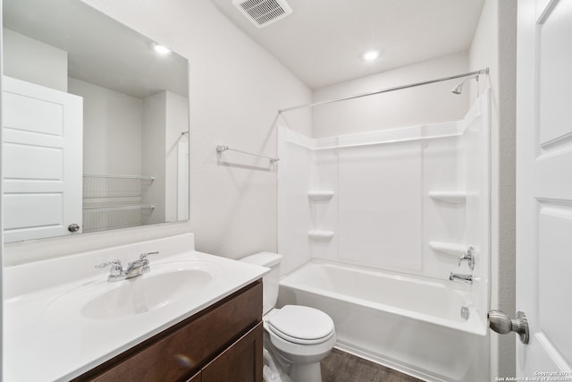 full bathroom with shower / tub combination, vanity, wood-type flooring, and toilet