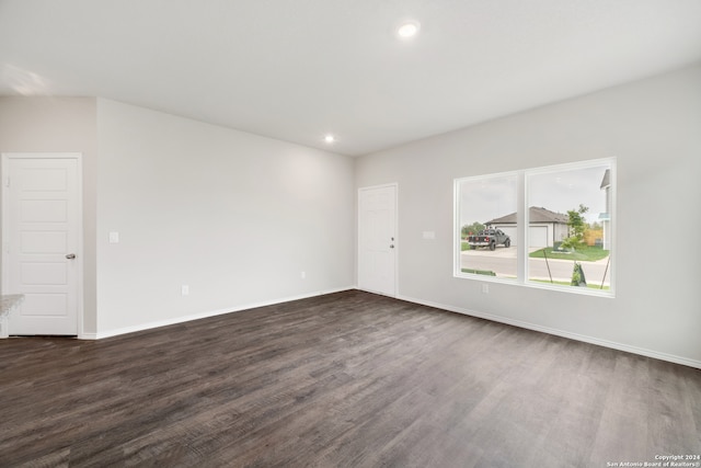 empty room with dark hardwood / wood-style floors