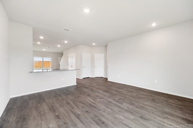 unfurnished living room with dark hardwood / wood-style floors