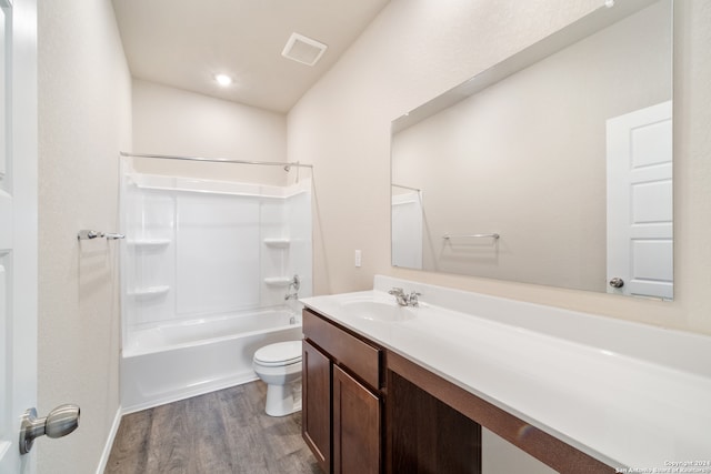 full bathroom with vanity, tub / shower combination, hardwood / wood-style flooring, and toilet