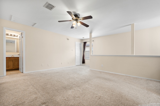 carpeted spare room featuring ceiling fan