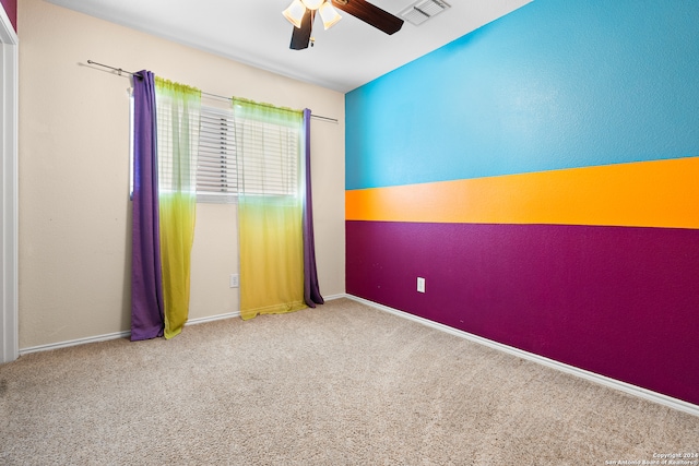 empty room featuring carpet flooring and ceiling fan