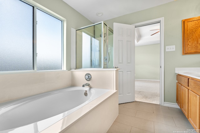 bathroom featuring shower with separate bathtub, tile patterned floors, vanity, and ceiling fan