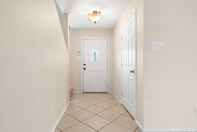 doorway to outside with light tile patterned floors