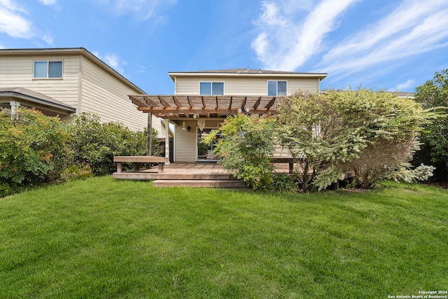 rear view of property featuring a pergola, a lawn, and a deck