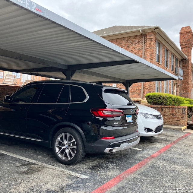 view of parking / parking lot featuring a carport