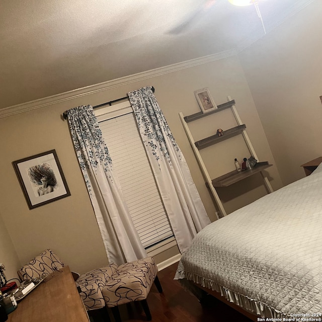 bedroom with crown molding, ceiling fan, and hardwood / wood-style flooring