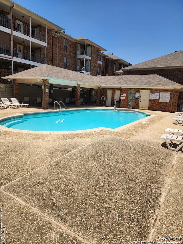 view of swimming pool featuring a patio area