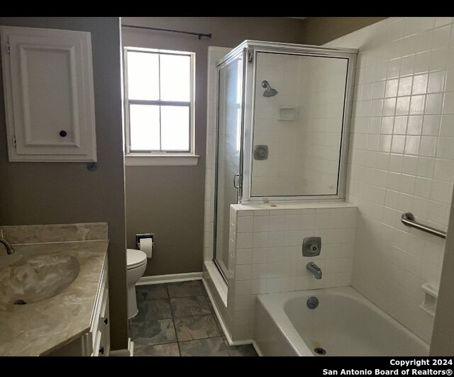 full bathroom featuring vanity, toilet, tile patterned floors, and separate shower and tub