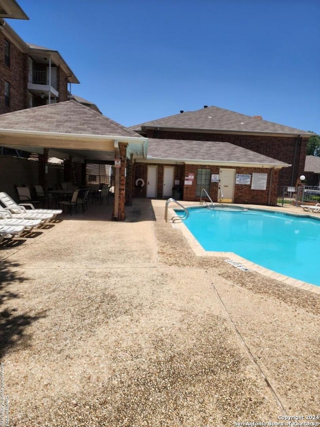 view of swimming pool featuring a patio area