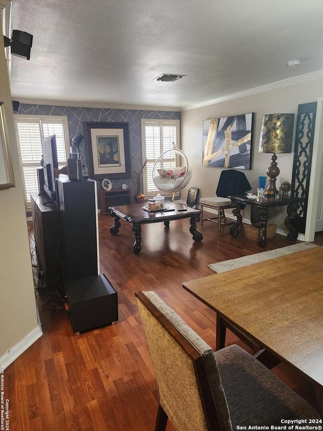 living room with wood-type flooring, crown molding, and a textured ceiling