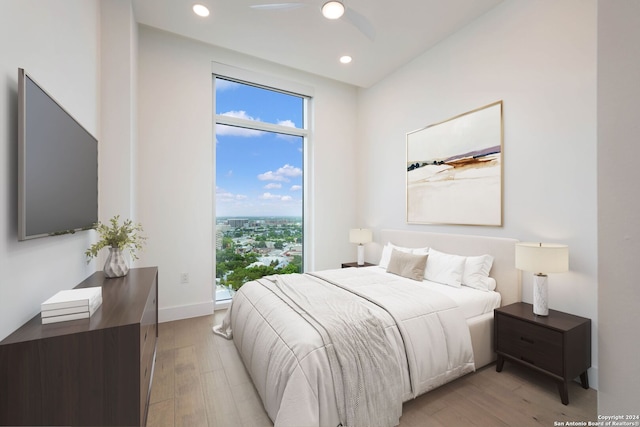 bedroom with light wood-type flooring and ceiling fan