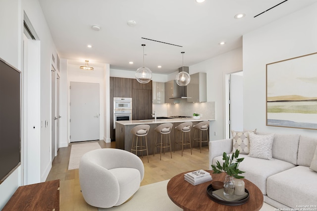 living room with light hardwood / wood-style flooring and sink