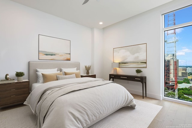 bedroom with light wood-type flooring and ceiling fan