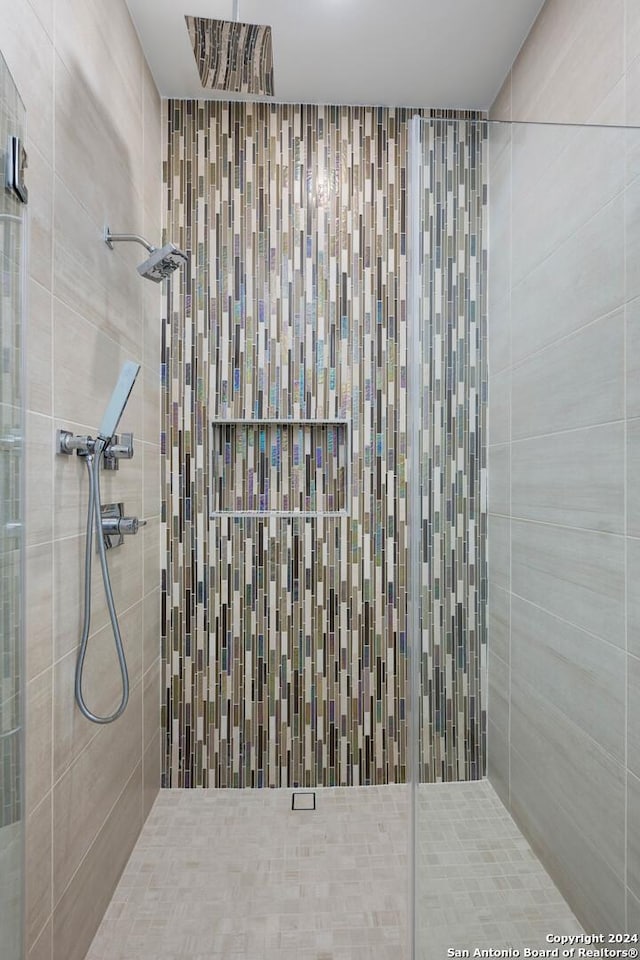 bathroom with tiled shower