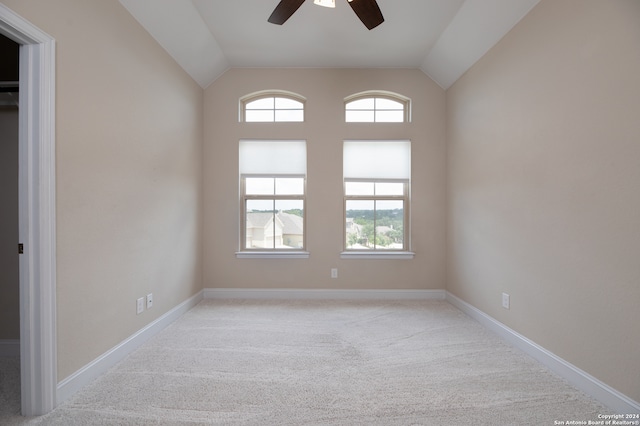 spare room with lofted ceiling, carpet, and ceiling fan