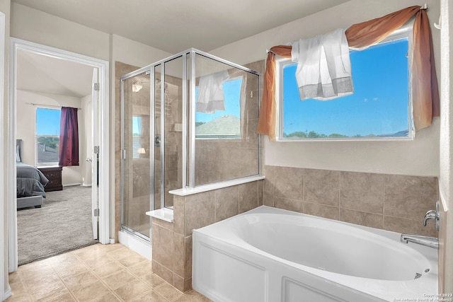 bathroom featuring tile patterned flooring, a healthy amount of sunlight, and separate shower and tub