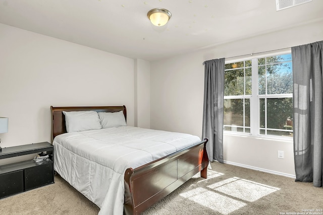 bedroom featuring light colored carpet