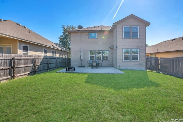 rear view of property with a patio and a yard