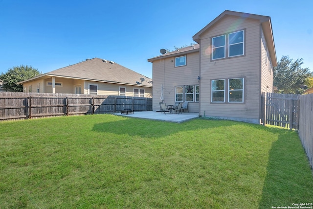 rear view of house with a patio area and a yard