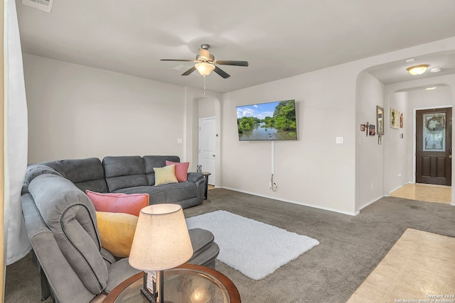 tiled living room featuring ceiling fan