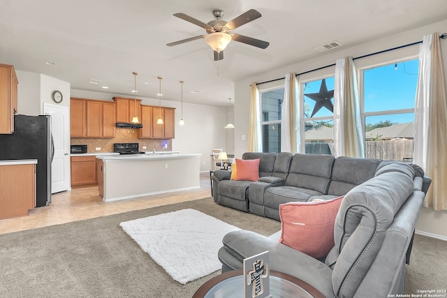 living room with light colored carpet and ceiling fan