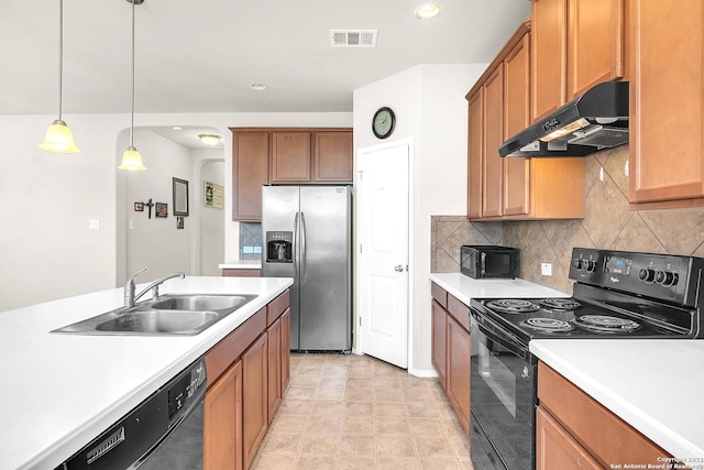 kitchen featuring decorative light fixtures, black appliances, decorative backsplash, sink, and light tile patterned floors