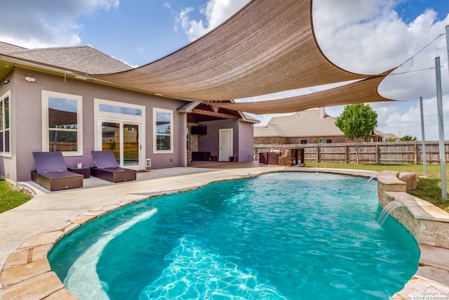 view of pool featuring pool water feature and a patio