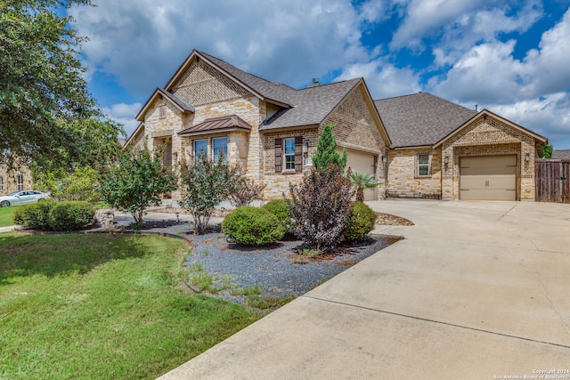 view of front facade with a garage and a front lawn