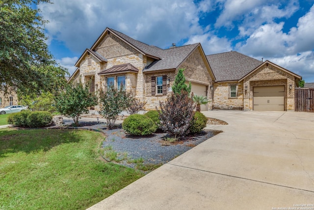 view of front of house with a garage and a front lawn