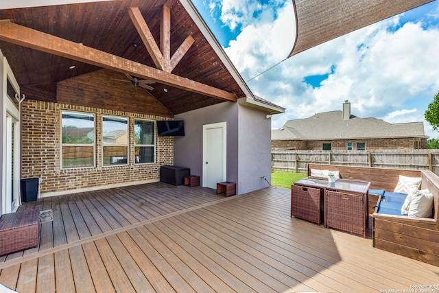 wooden deck featuring outdoor lounge area and ceiling fan