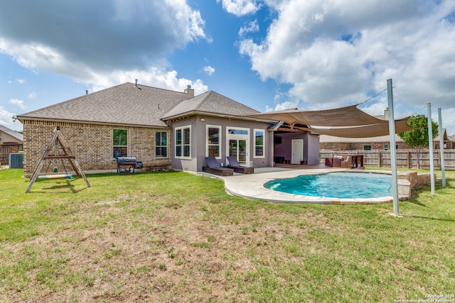 view of pool with a patio, a yard, area for grilling, and central AC