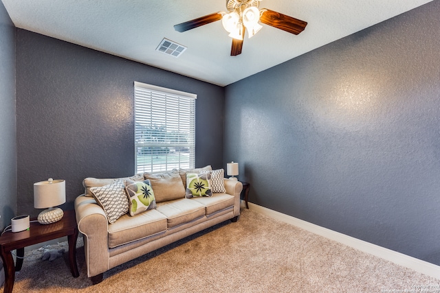 carpeted living room featuring ceiling fan