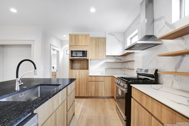 218 Pinckney St, San Antonio, TX 78209 - kitchen featuring wall chimney exhaust hood, light stone countertops, open shelves, a sink, and stainless steel appliances