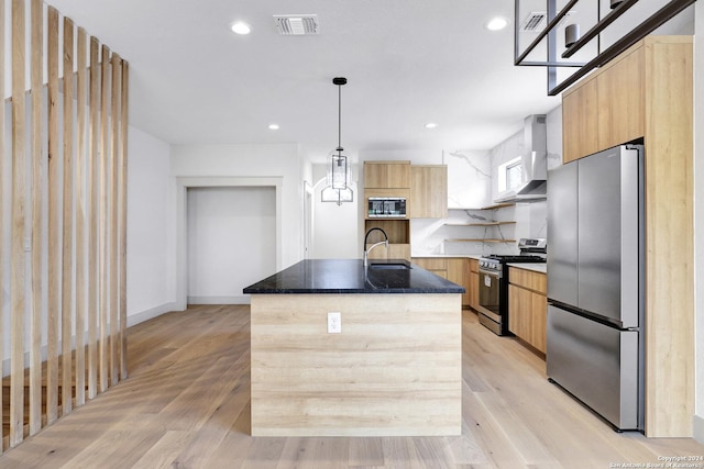 218 Pinckney St, San Antonio, TX 78209 - kitchen with wall chimney range hood, a center island with sink, modern cabinets, stainless steel appliances, and a sink
