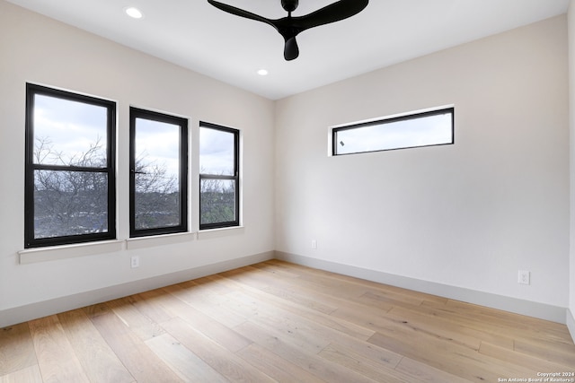 empty room featuring ceiling fan and light hardwood / wood-style flooring